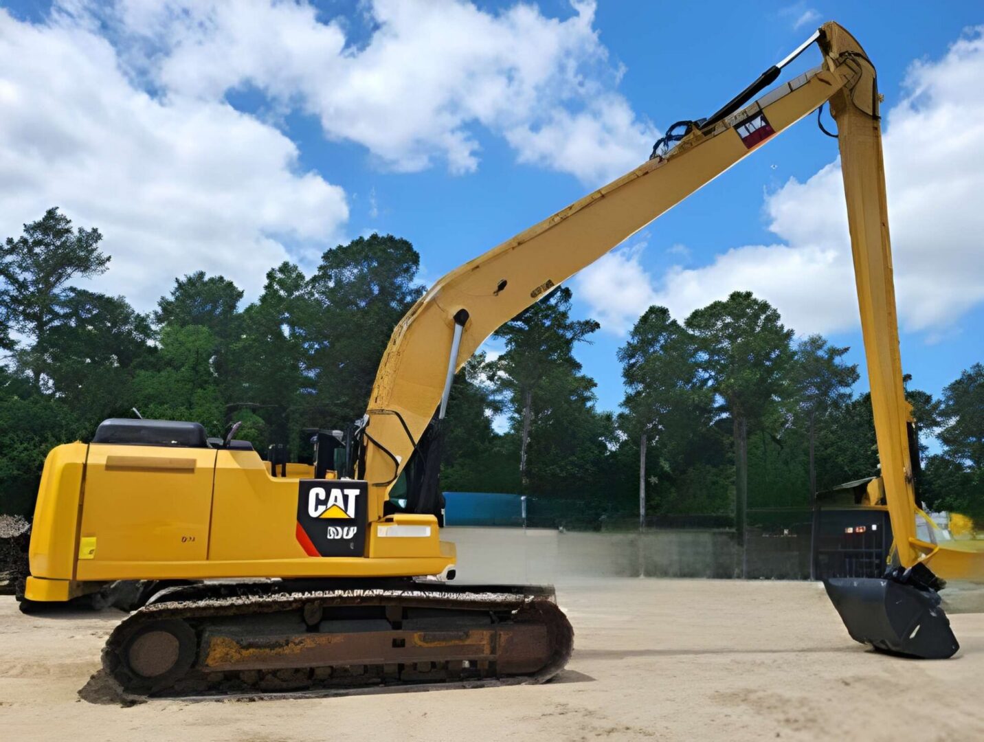 Yellow excavator with extended arm